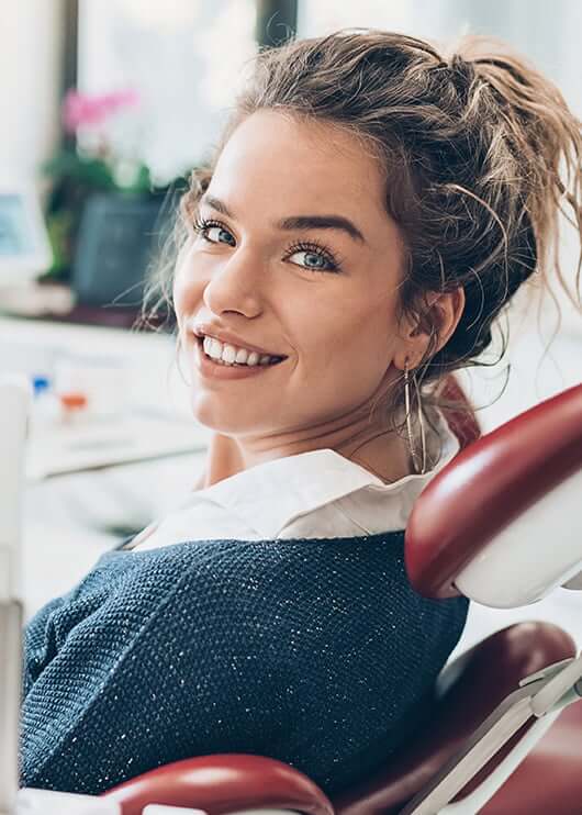 smiling woman sitting in a dental chair