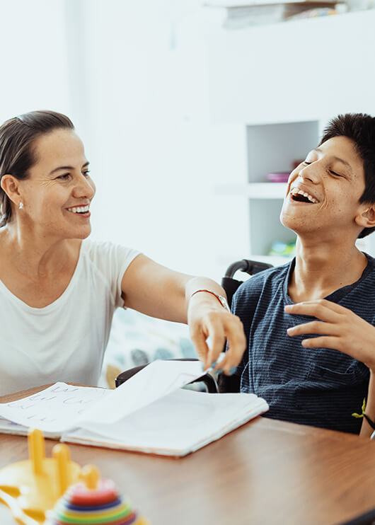 mother helping her special needs son with school work